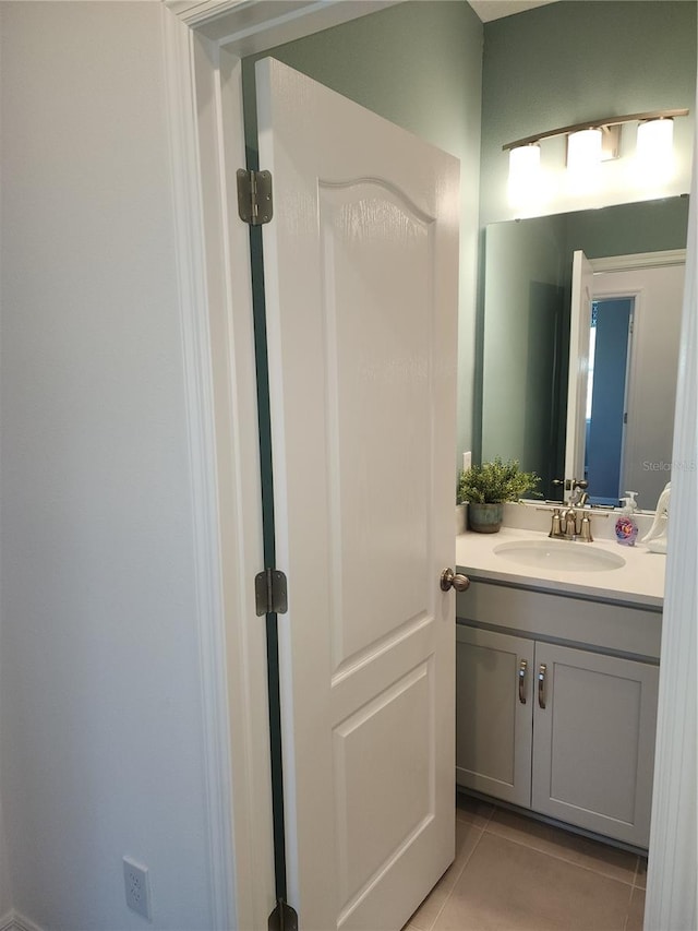 bathroom with tile patterned flooring and vanity