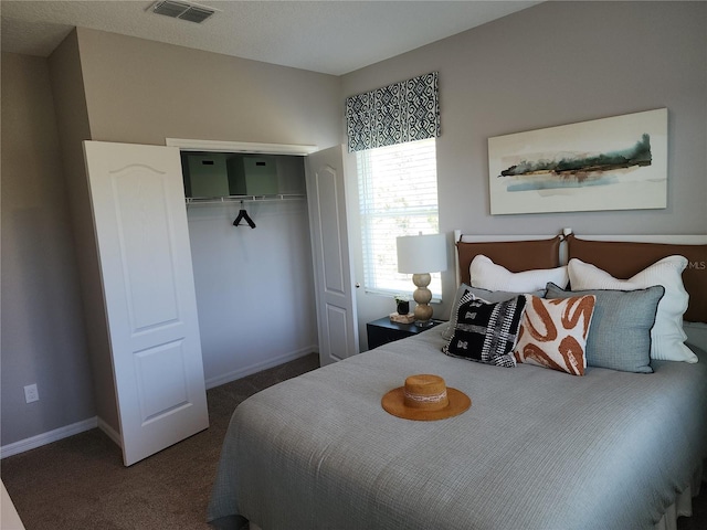 bedroom featuring carpet floors, a closet, visible vents, and baseboards