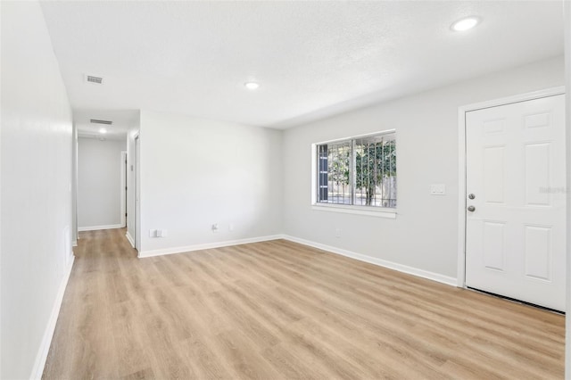 unfurnished room featuring light wood-type flooring