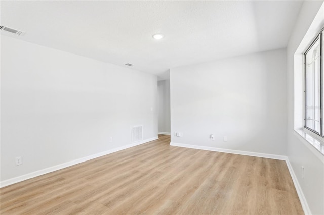 spare room featuring light hardwood / wood-style flooring