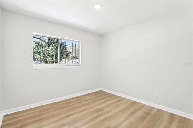 unfurnished room with light wood-type flooring