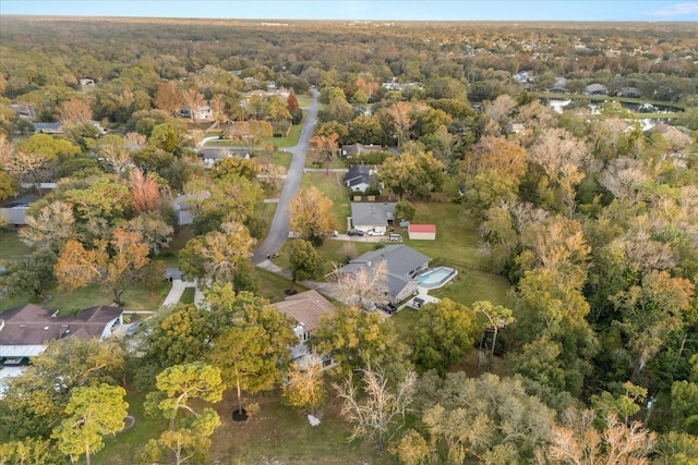 birds eye view of property featuring a wooded view