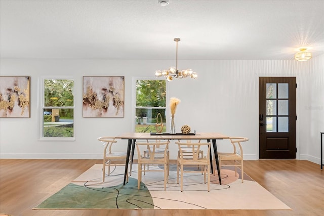 dining room featuring light wood-style floors and baseboards