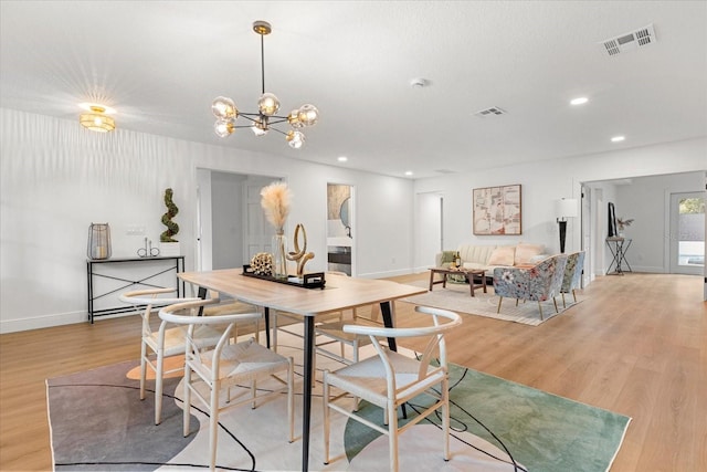 dining space with light wood finished floors, baseboards, visible vents, and recessed lighting