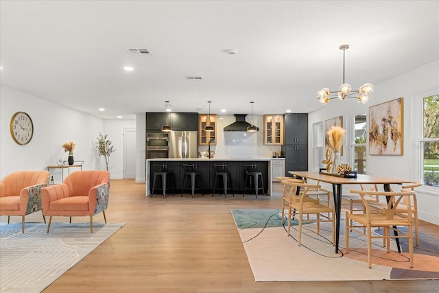 dining room featuring recessed lighting, visible vents, light wood-style floors, a chandelier, and baseboards