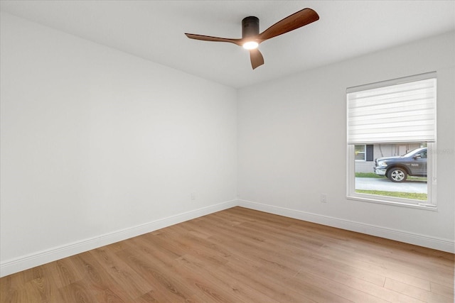 unfurnished room featuring a ceiling fan, baseboards, and light wood finished floors