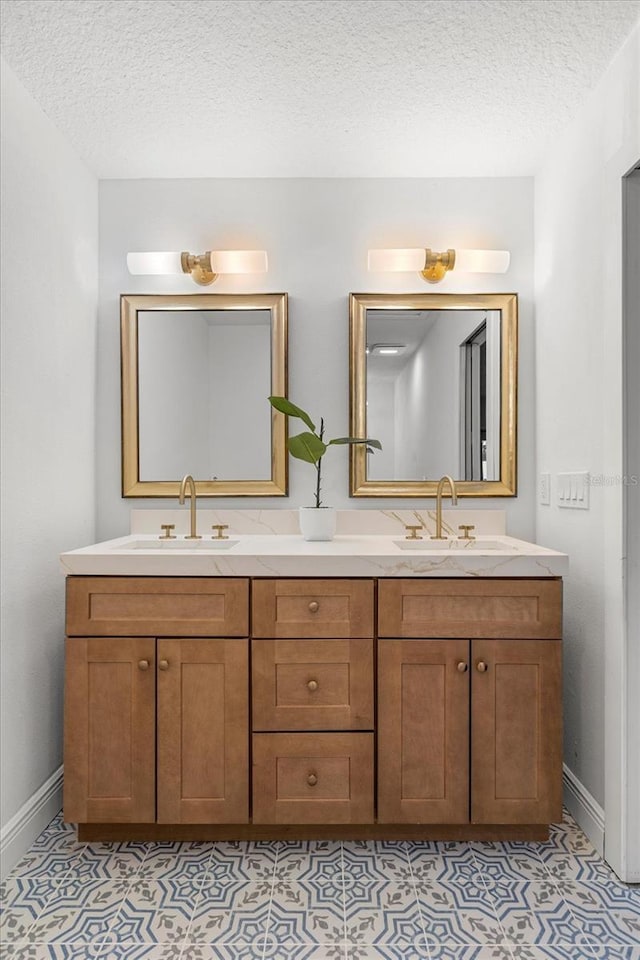 full bath featuring tile patterned flooring, a sink, and a textured ceiling