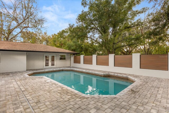 view of pool featuring a fenced in pool, french doors, a patio, and fence