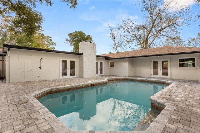 pool with a patio area and french doors