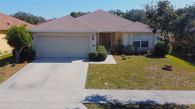 single story home featuring a garage and a front yard