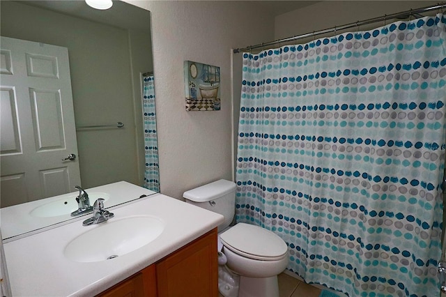 bathroom featuring vanity, toilet, curtained shower, and tile patterned flooring