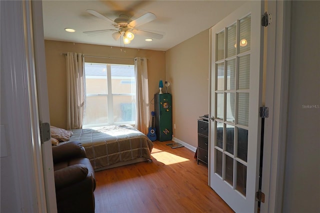 bedroom with ceiling fan and light wood-type flooring