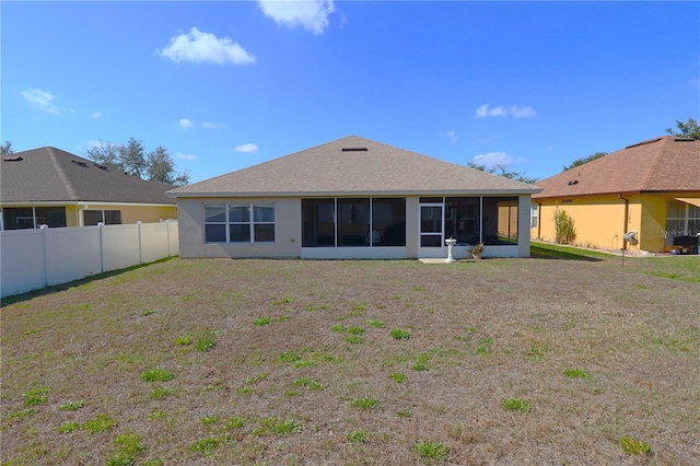 rear view of property featuring a sunroom