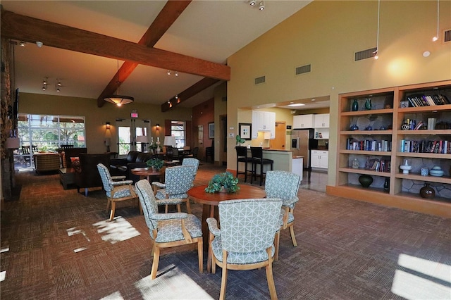 dining space featuring lofted ceiling with beams and carpet flooring