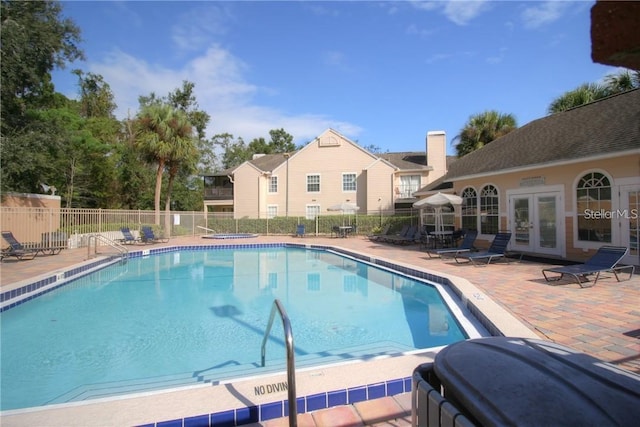 view of pool with a patio and french doors