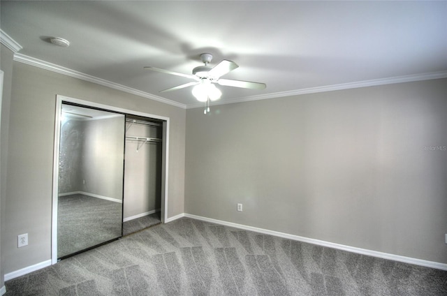 unfurnished bedroom featuring ceiling fan, a closet, ornamental molding, and carpet