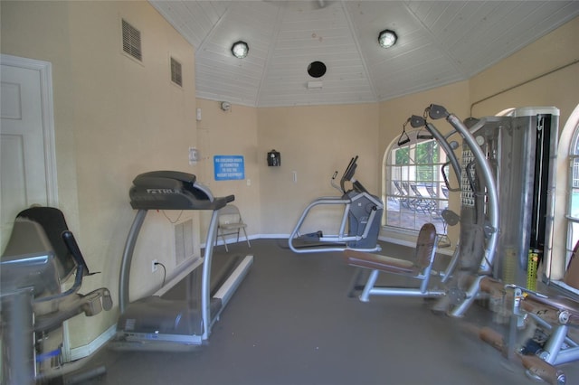 gym with lofted ceiling and baseboards