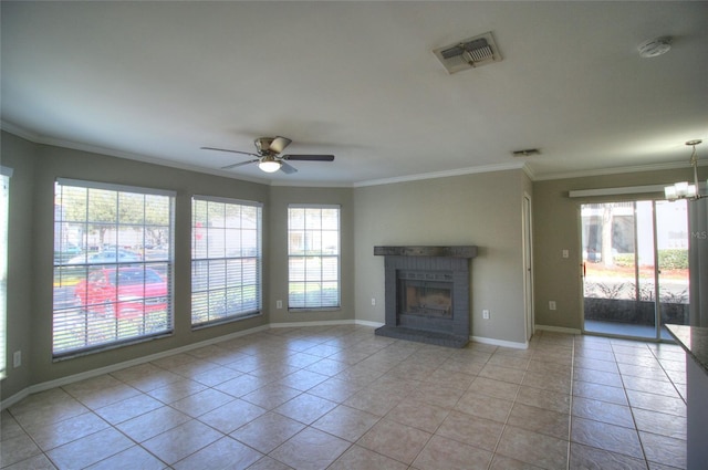 unfurnished living room with ceiling fan, light tile patterned floors, a brick fireplace, crown molding, and baseboards