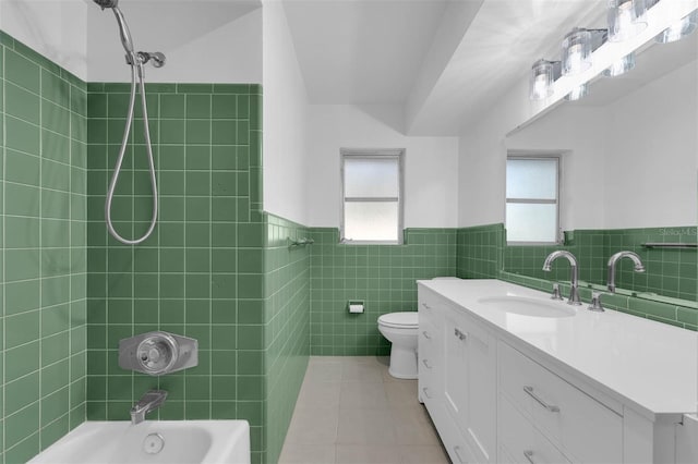 bathroom with a healthy amount of sunlight, wainscoting, shower / tub combination, and tile patterned floors