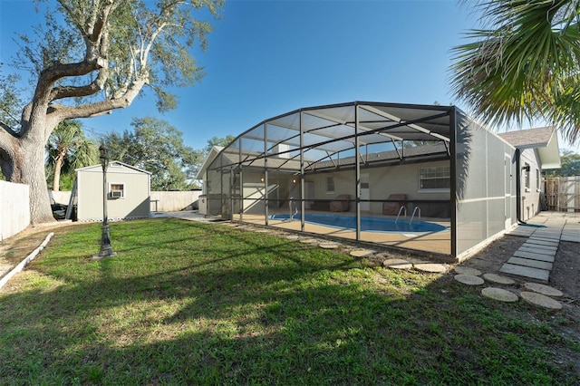 view of yard featuring glass enclosure, an outdoor structure, and a fenced backyard