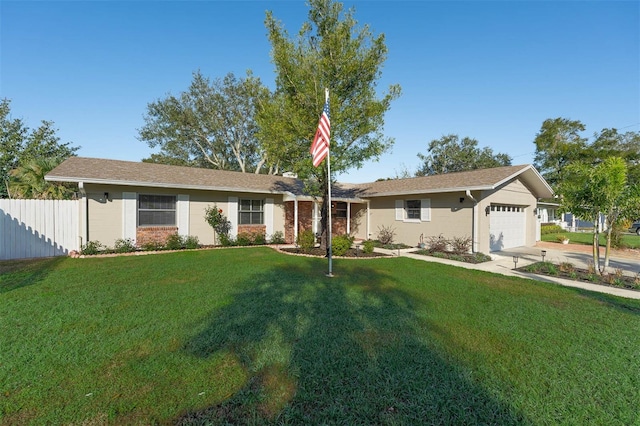 ranch-style home featuring concrete driveway, a front lawn, an attached garage, and fence