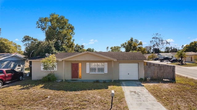 ranch-style home featuring a garage and a front lawn