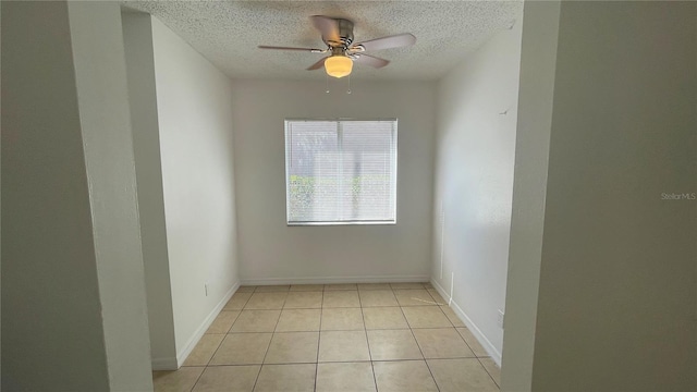 tiled spare room featuring ceiling fan and a textured ceiling