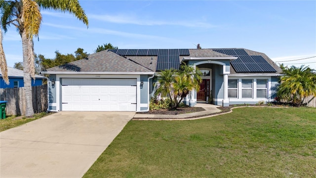 ranch-style house with a garage, a front yard, and solar panels