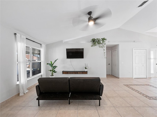 living room with ceiling fan, lofted ceiling, and light tile patterned floors