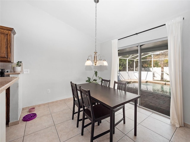 dining room with light tile patterned flooring and vaulted ceiling