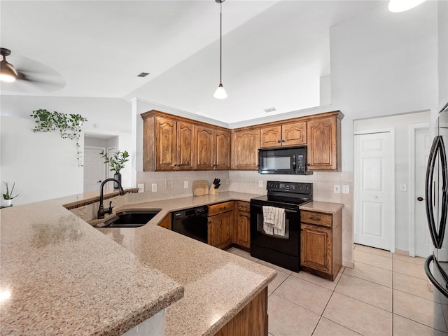 kitchen with sink, light tile patterned floors, hanging light fixtures, tasteful backsplash, and black appliances