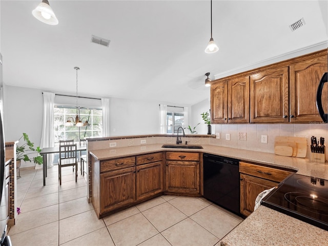 kitchen with light tile patterned flooring, pendant lighting, dishwasher, sink, and backsplash