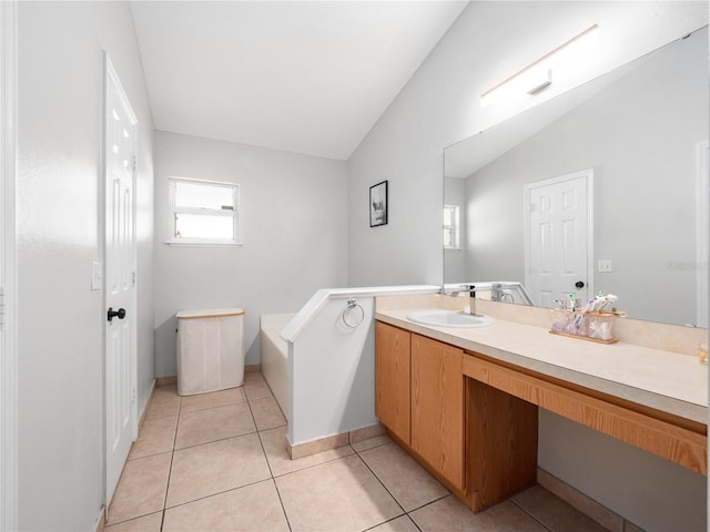 bathroom featuring vanity, lofted ceiling, and tile patterned floors