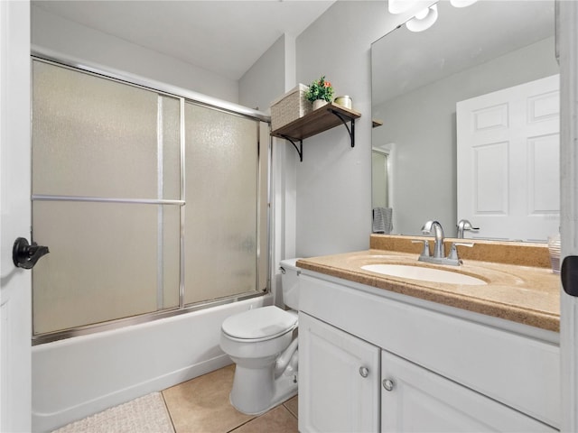 full bathroom featuring toilet, tile patterned floors, shower / bath combination with glass door, and vanity