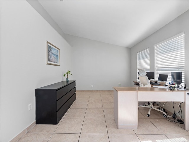 office featuring lofted ceiling and light tile patterned floors