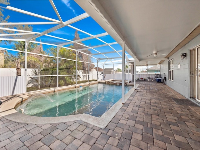 view of pool with a lanai, a patio, and ceiling fan