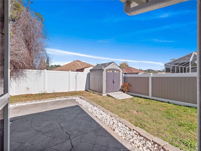 view of yard with a shed and a patio area