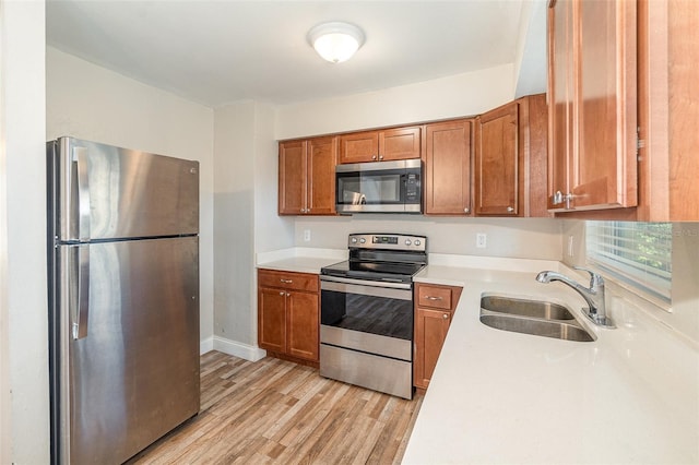 kitchen featuring sink, light hardwood / wood-style flooring, and stainless steel appliances