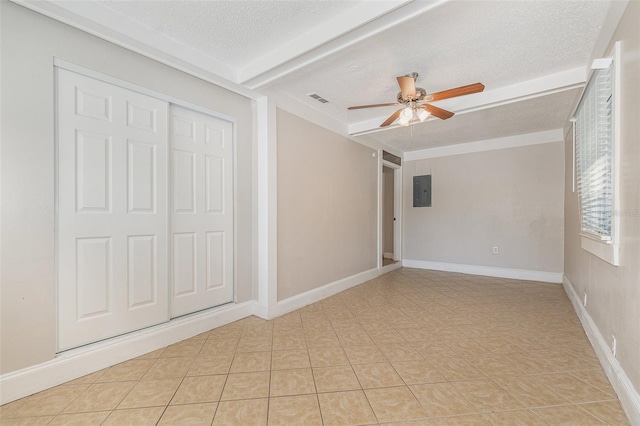 unfurnished bedroom with light tile patterned flooring, electric panel, ceiling fan, a textured ceiling, and a closet