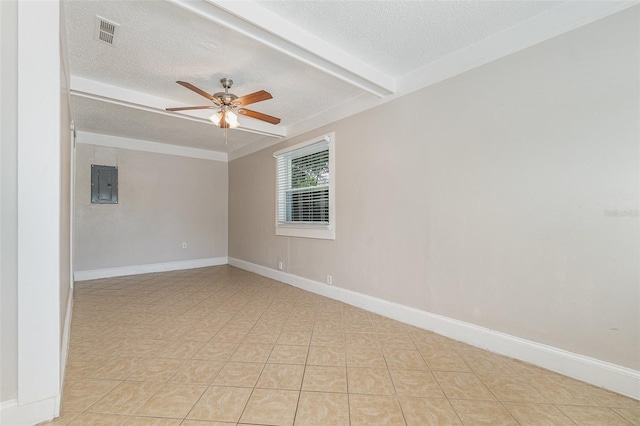 tiled empty room with a textured ceiling, electric panel, and ceiling fan