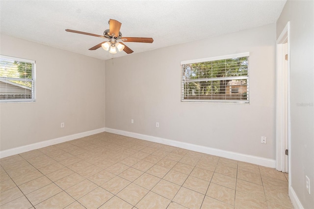 spare room with a textured ceiling and ceiling fan