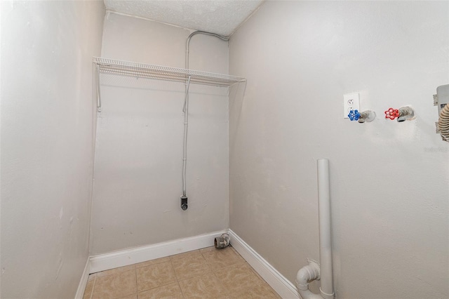 laundry area featuring washer hookup and a textured ceiling