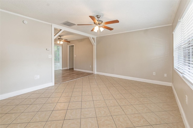 empty room with crown molding, ceiling fan, and a textured ceiling