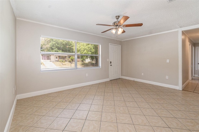 spare room featuring ornamental molding, ceiling fan, and a textured ceiling