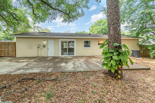 rear view of property featuring cooling unit and a patio area