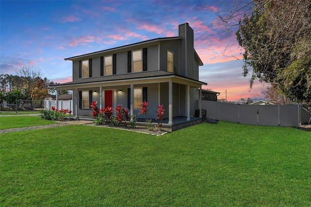 view of front of house with a yard and covered porch