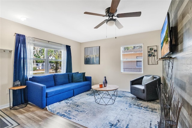 living room featuring ceiling fan and light wood-type flooring