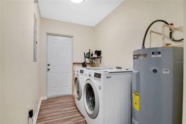 laundry room featuring washing machine and clothes dryer, electric water heater, and light hardwood / wood-style flooring