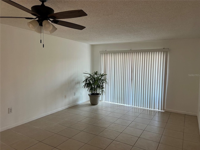 unfurnished room featuring ceiling fan, a textured ceiling, and light tile patterned floors