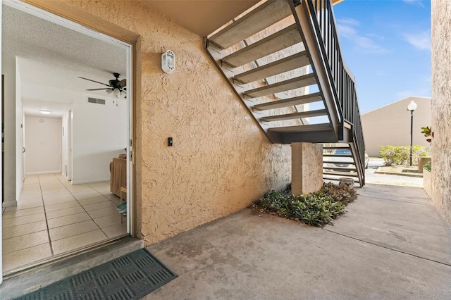 5201 Vineland Rd Unit 112, Orlando, FL 32811 - property entrance with visible vents, a patio, and stucco siding